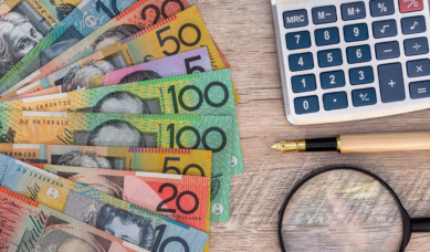 Australian Currency On Desk Beside Stationery